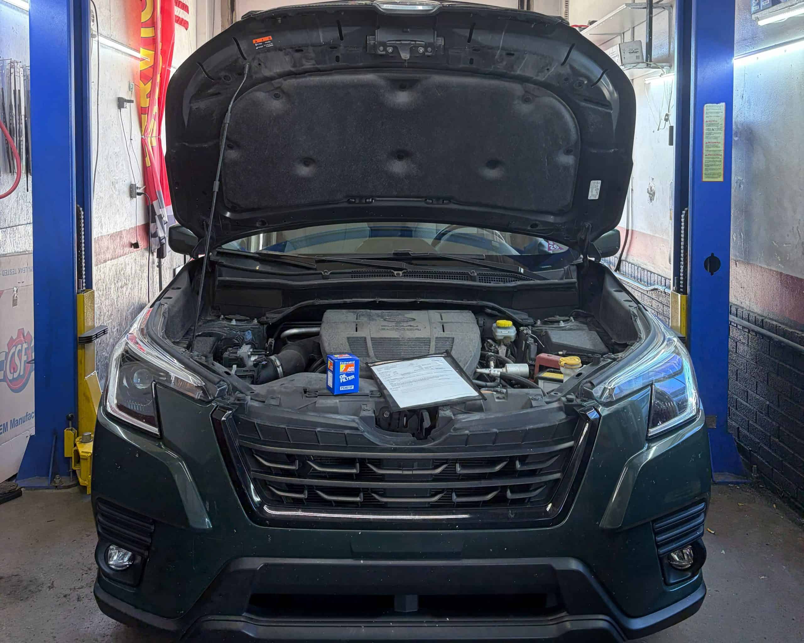 Car engine inspection at Allen's Quality Auto Care workshop.