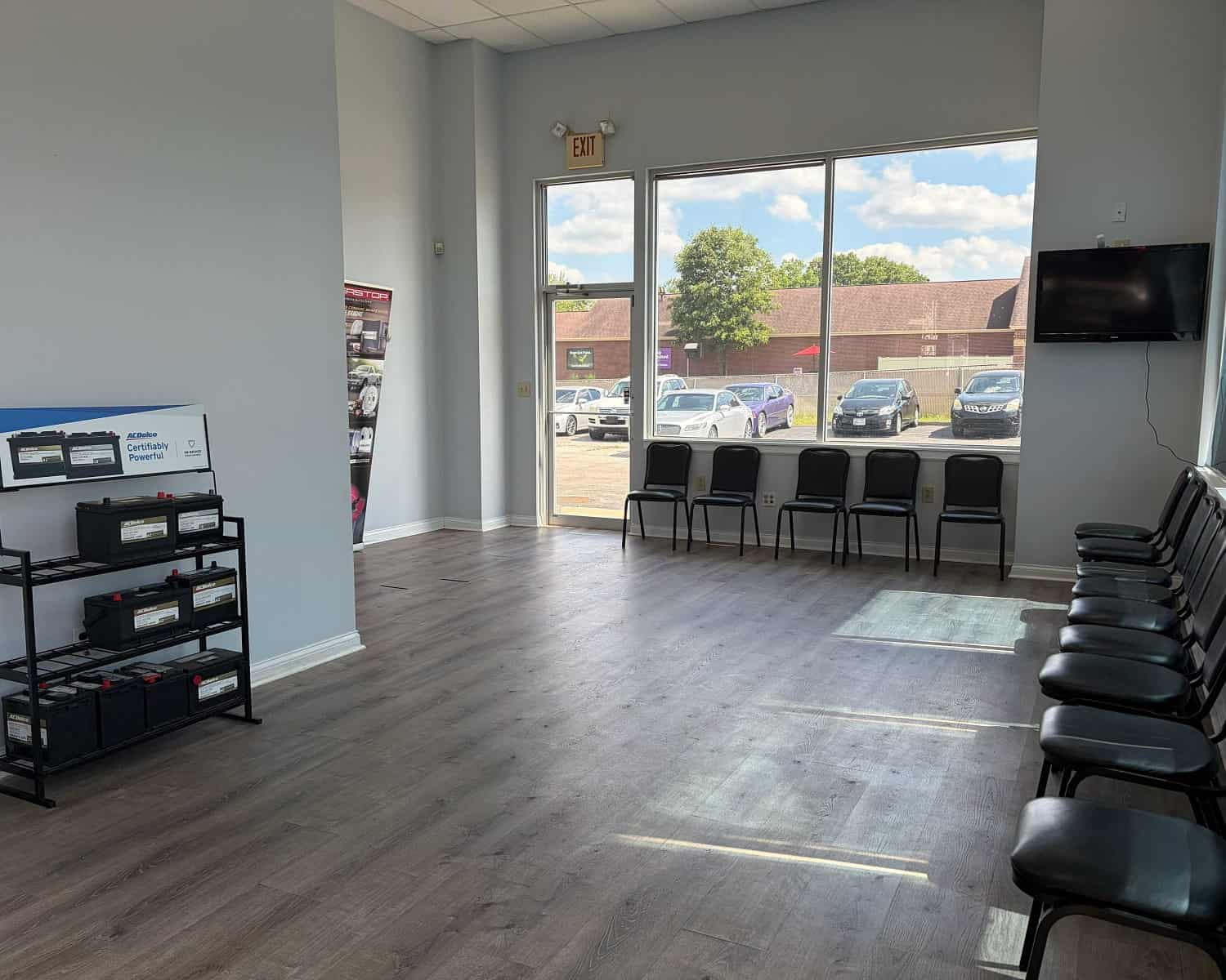Clean and modern auto repair shop waiting area with chairs and large window.