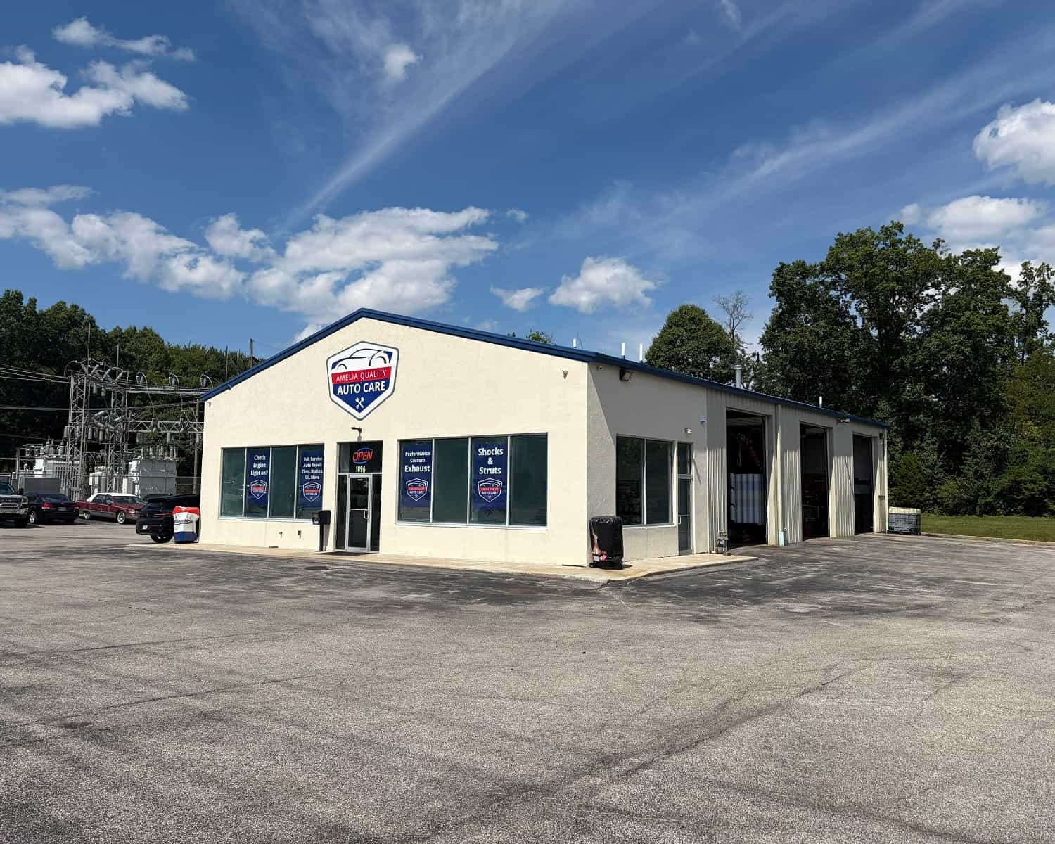 Auto repair shop building with Allen's Quality Auto Care sign under blue sky.