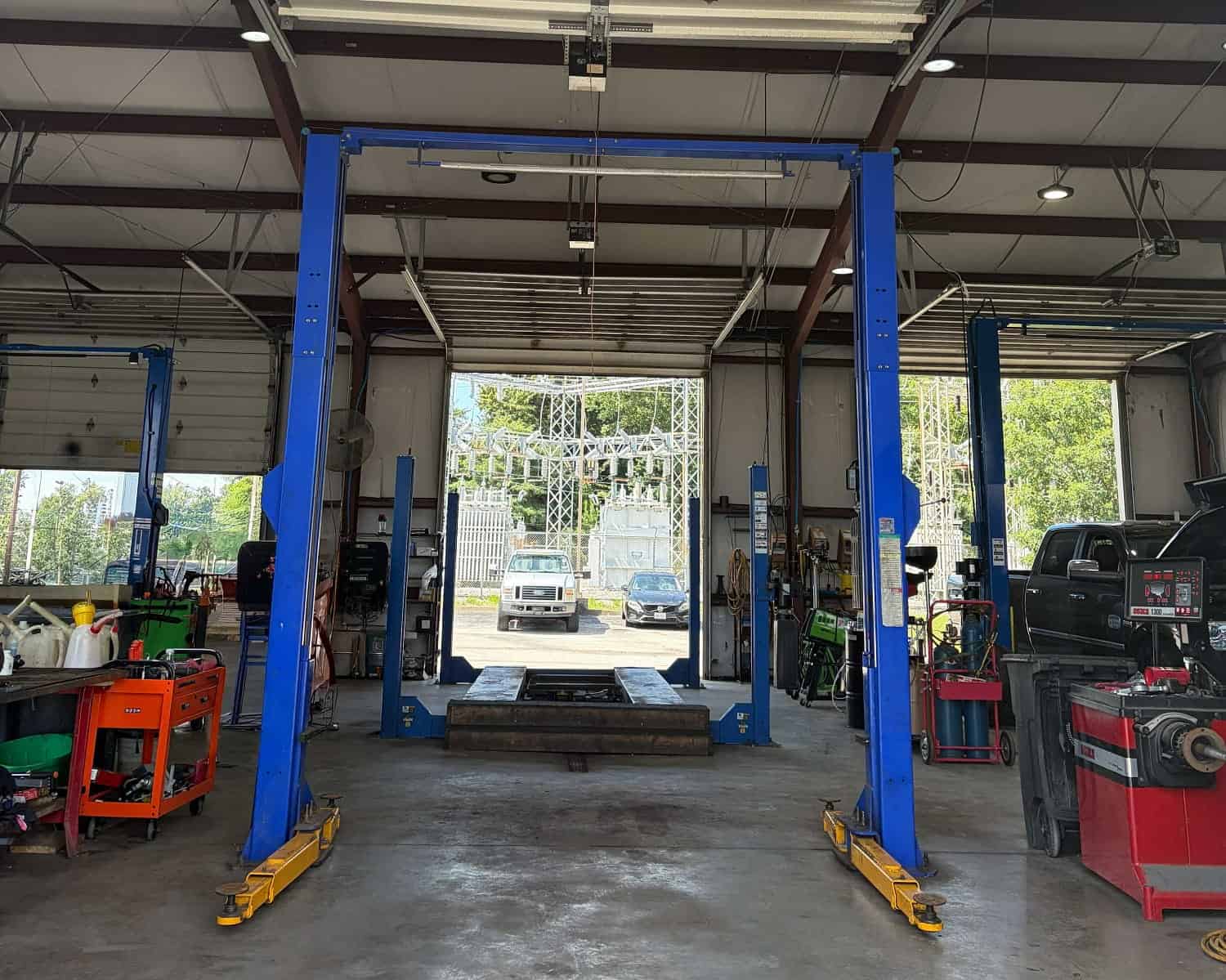 Automotive lift inside a busy auto repair shop at Allen's Quality Auto Care.